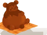 座るプラム・ピーのミルクチョコ