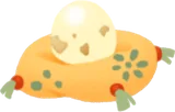 小さな卵が乗った黄色い座布団