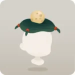 丸い卵が乗った緑色の座布団